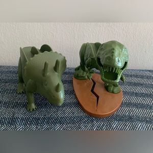 Two dinosaur taco holders